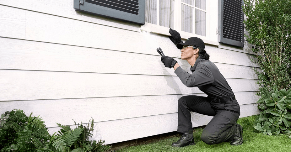 pest control technician inspecting property