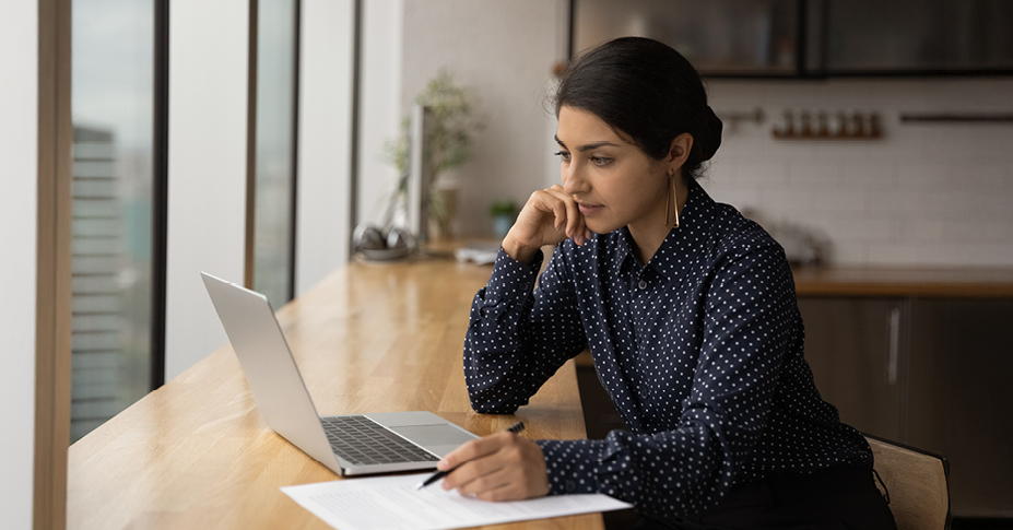woman looking at computer on desk